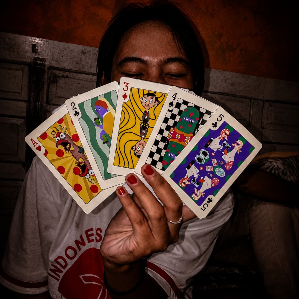 A hand fanning out cards from Waraqah's custom playing card deck